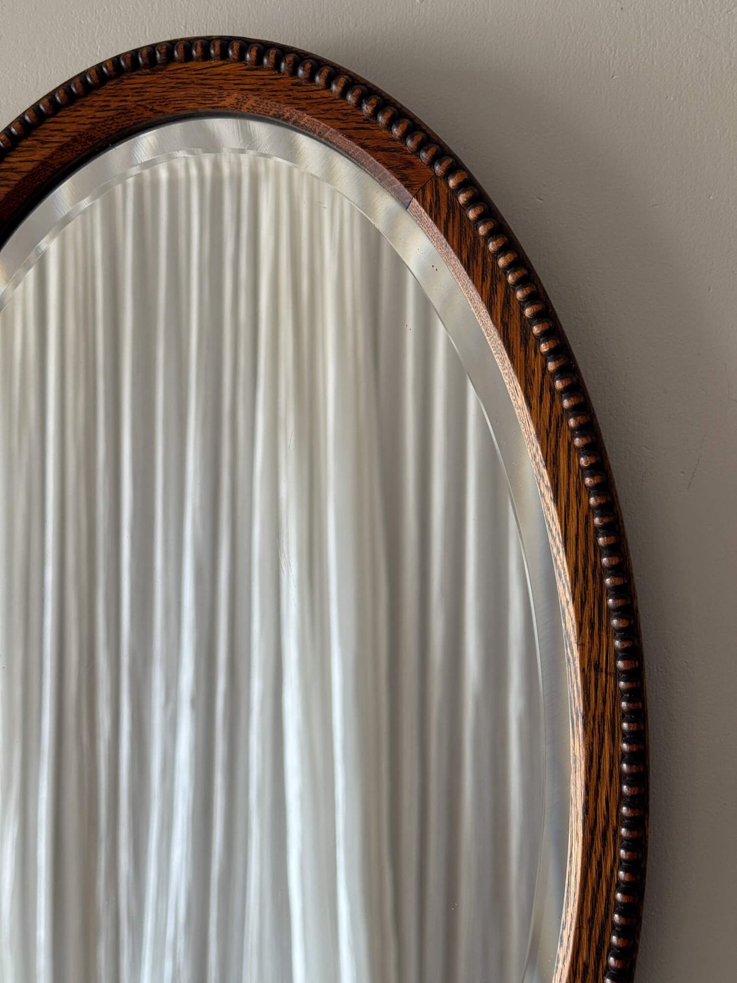 Antique oval oak mirror with bobbin detailing
