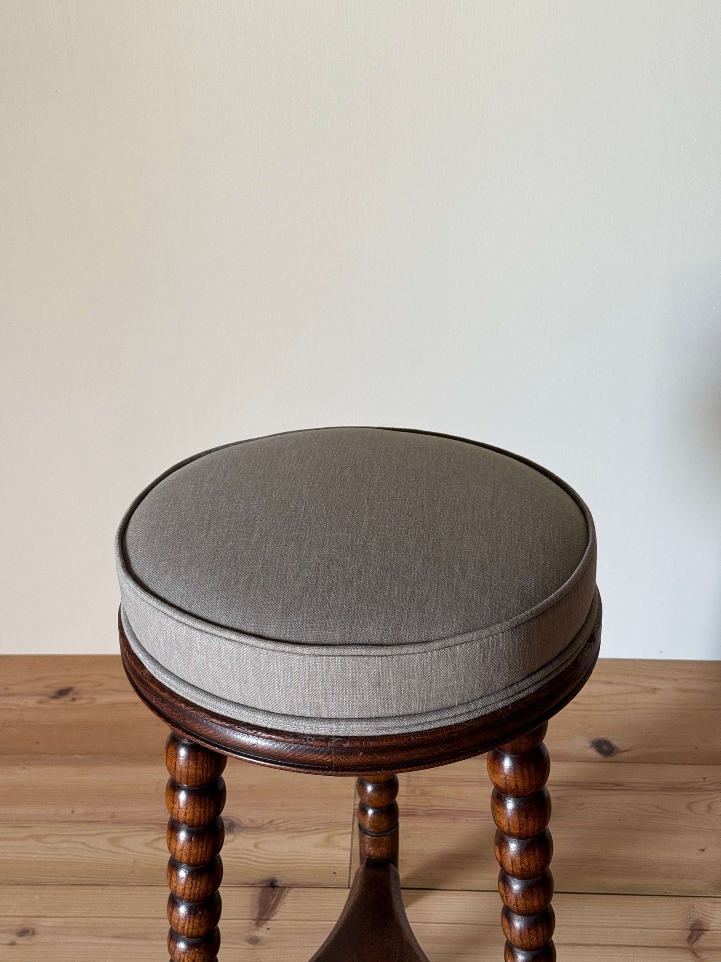 Antique upholstered bobbin stool