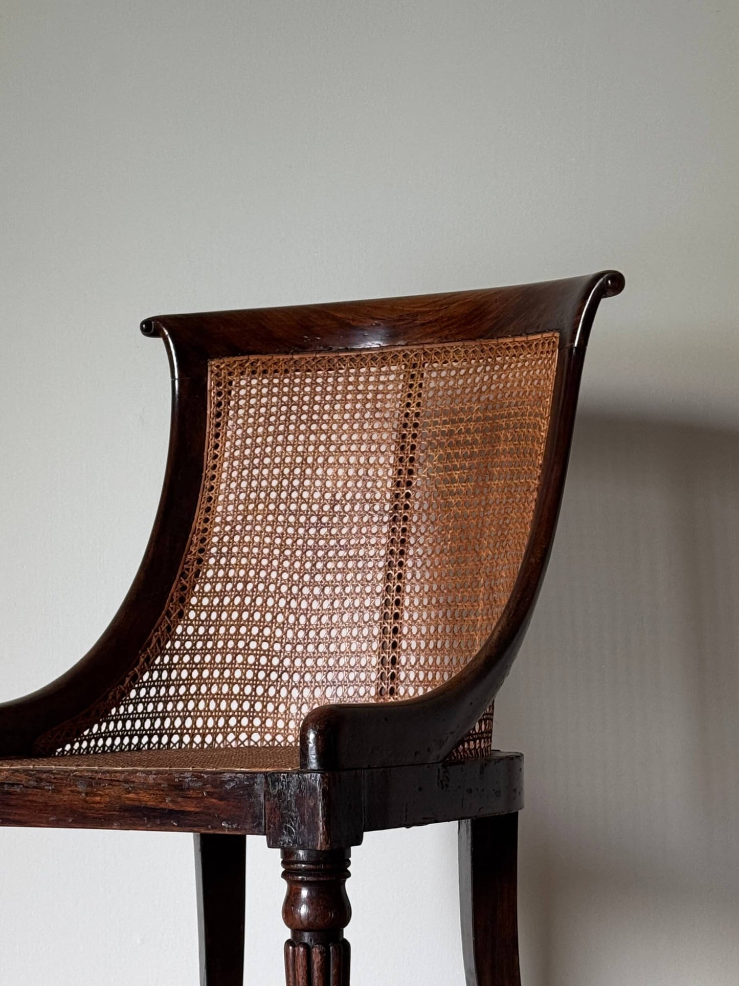 Regency caned bergère chair on fluted legs