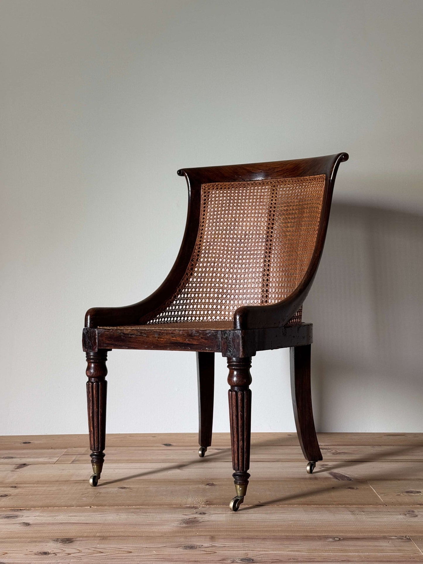 Regency caned bergère chair on fluted legs