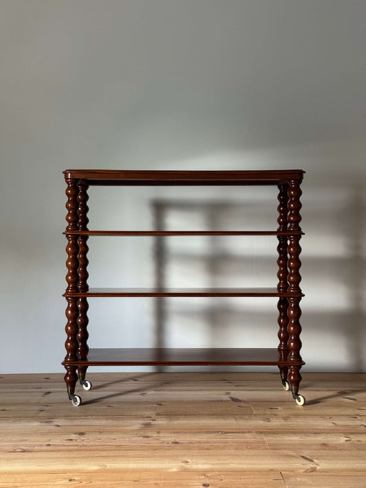 Victorian mahogany bobbin shelving unit on ceramic castors