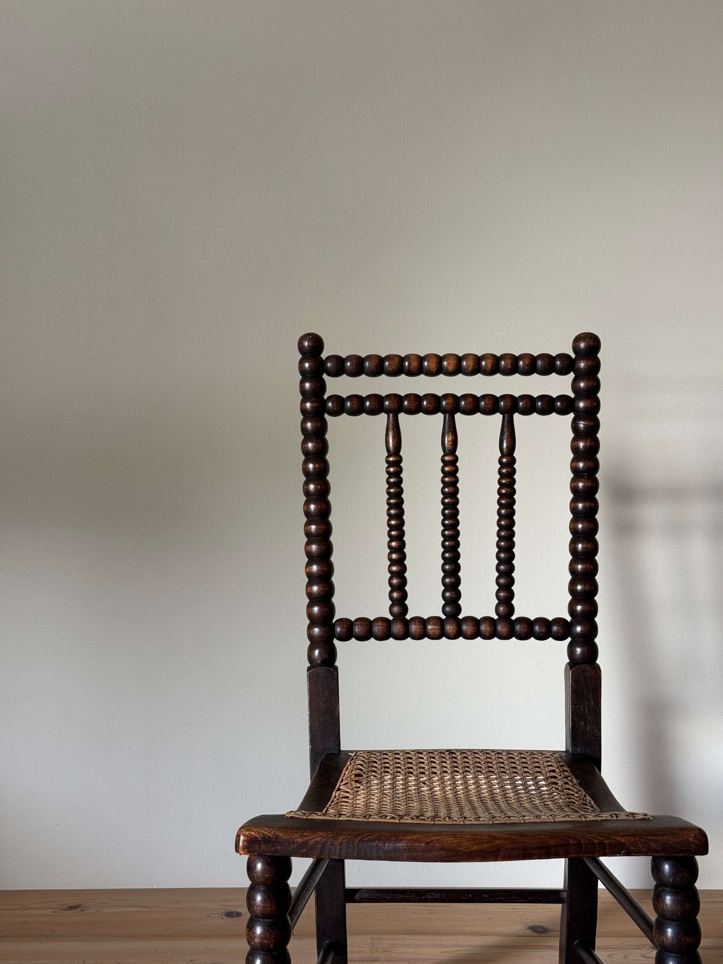 A Victorian bobbin chair with cane seat