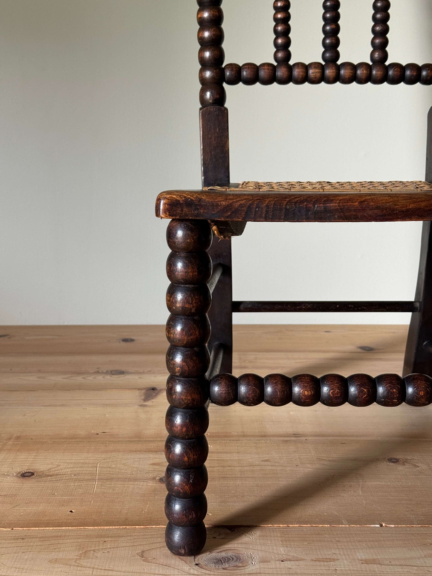 A Victorian bobbin chair with cane seat