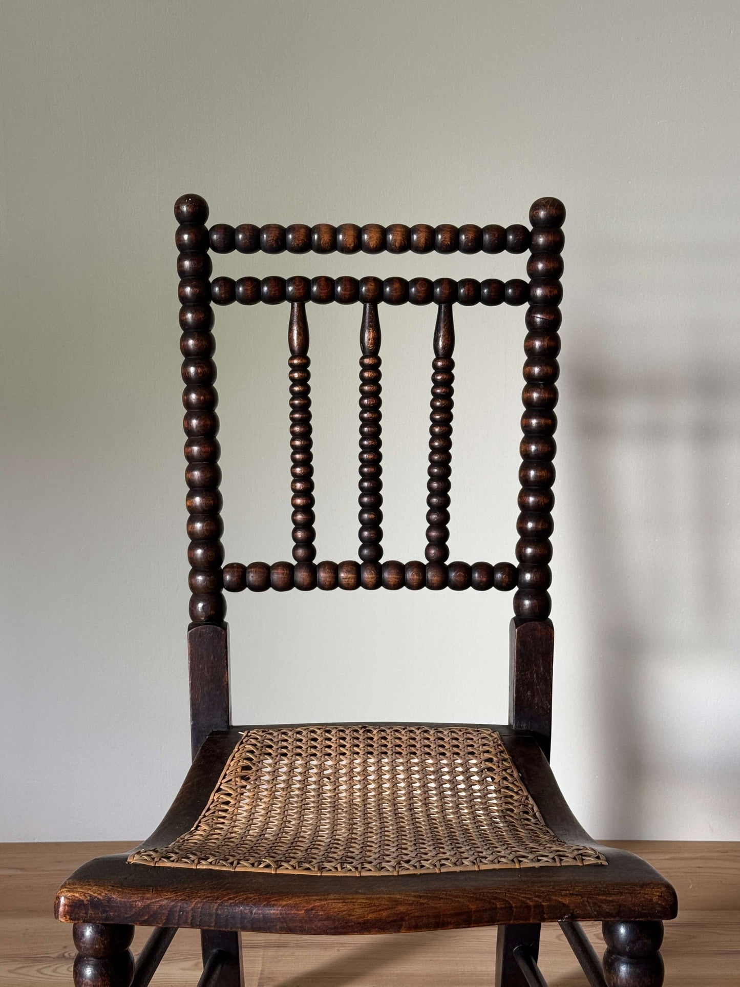 A Victorian bobbin chair with cane seat