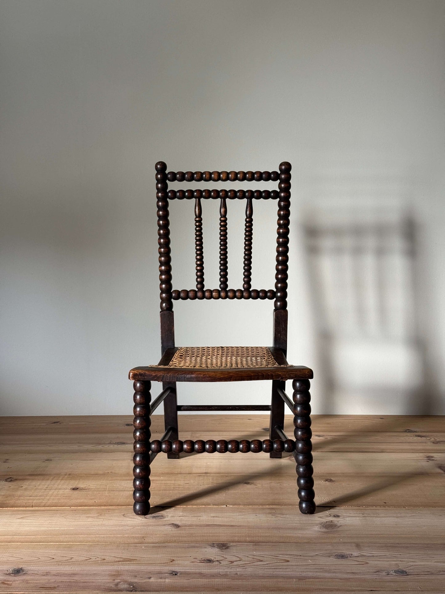 A Victorian bobbin chair with cane seat