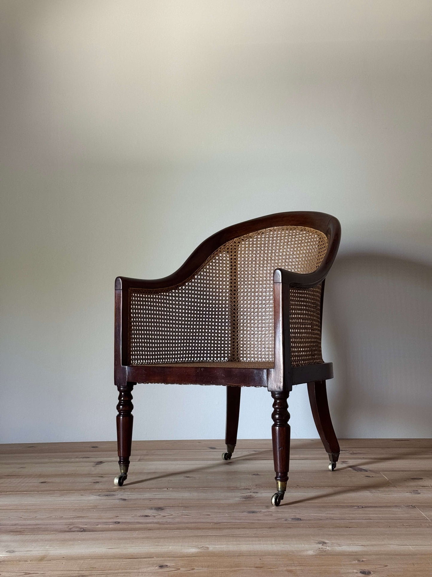 Antique beech bergere chair on castors