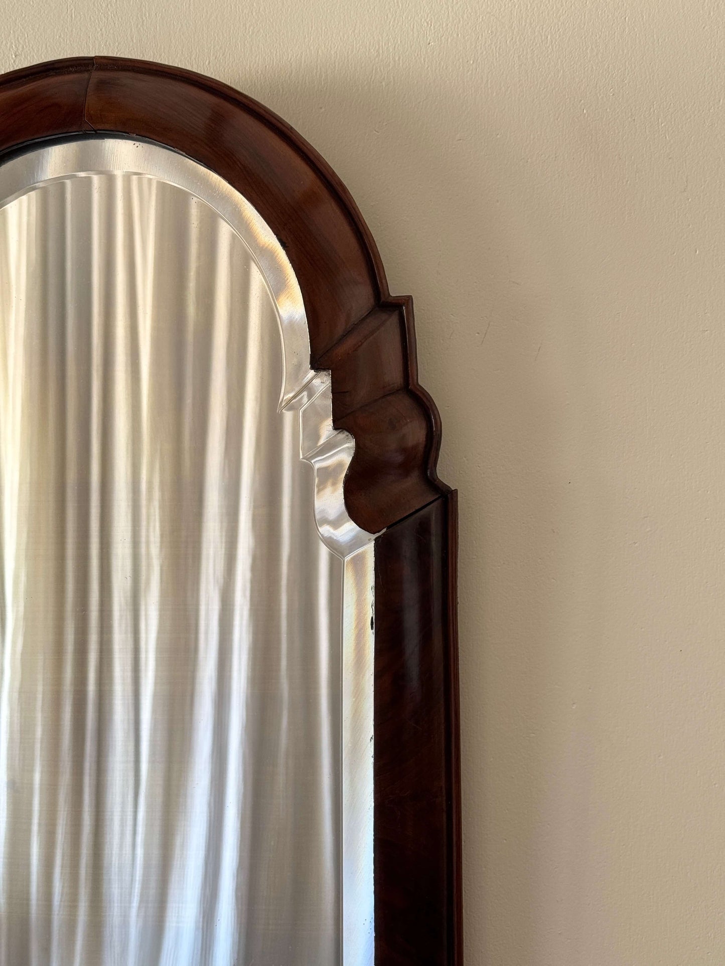 Antique walnut arched bevelled mirror