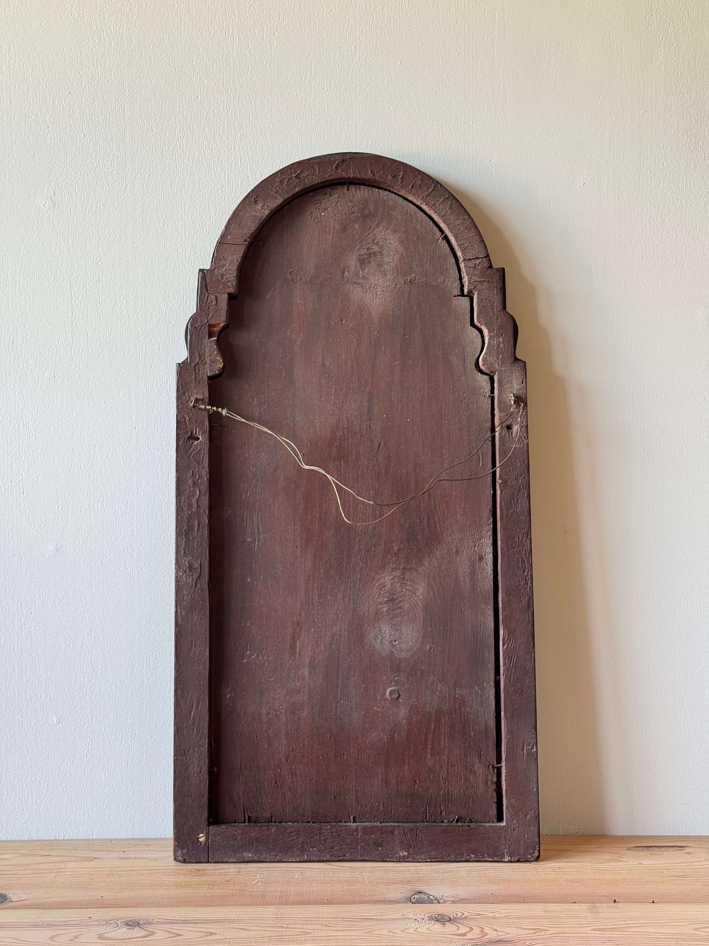 Antique walnut arched bevelled mirror