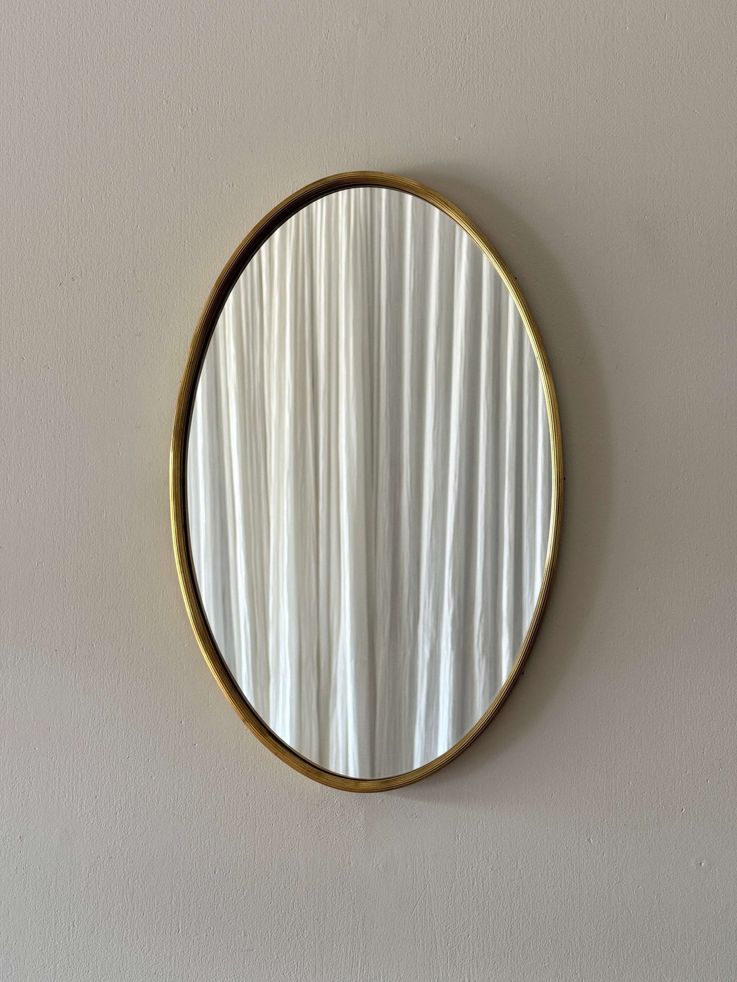 French mid-century oval brass mirror