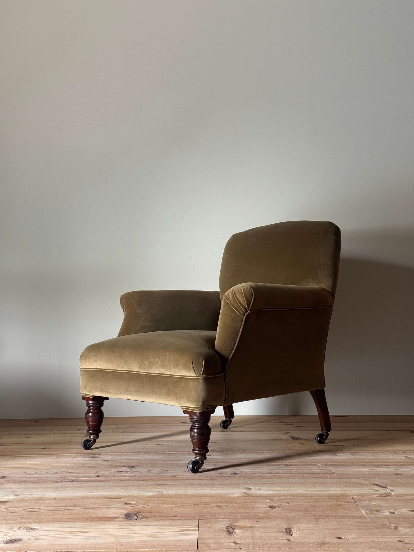 Antique Victorian upholstered armchair on castors