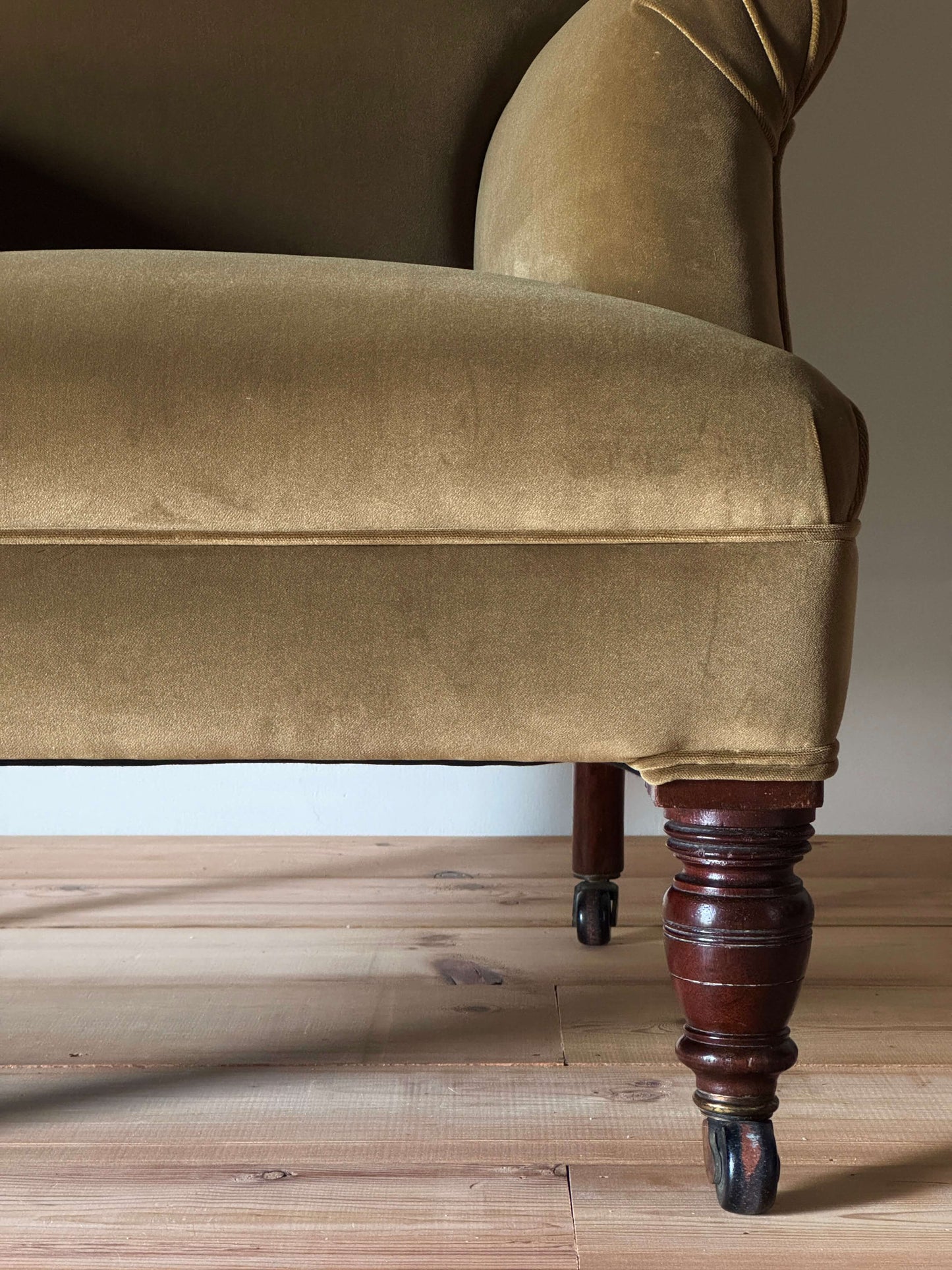 Antique Victorian upholstered armchair on castors