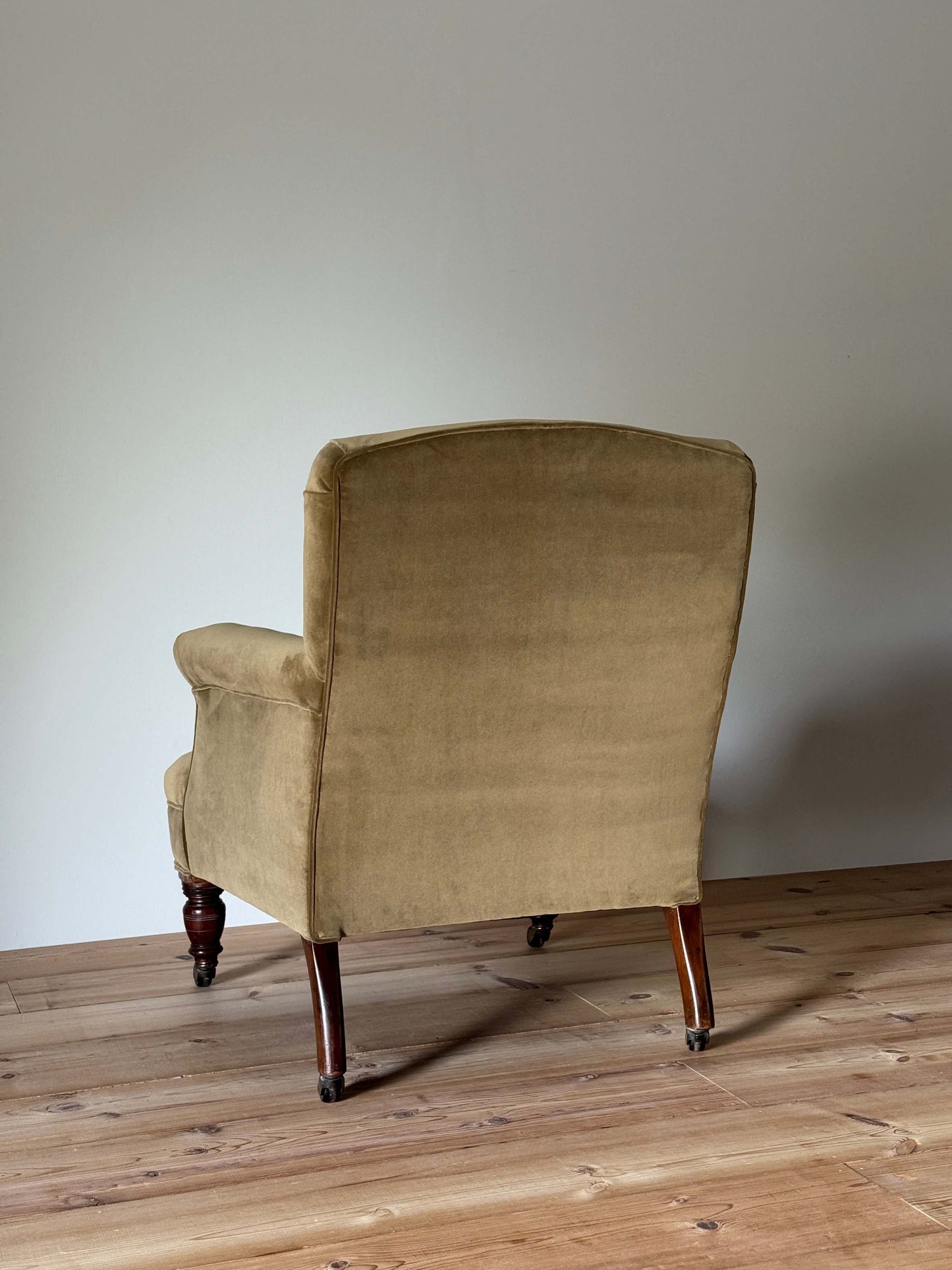 Antique Victorian upholstered armchair on castors