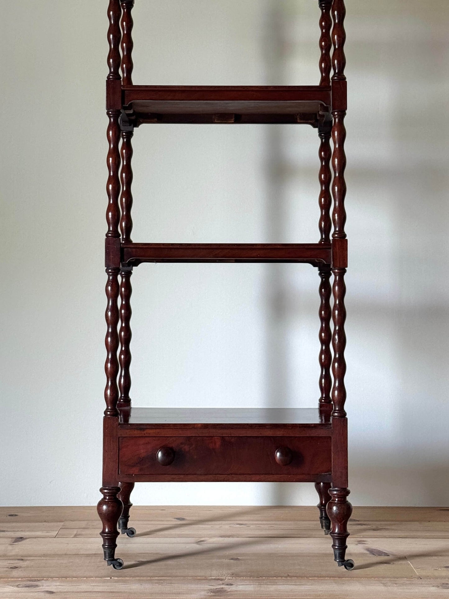 Victorian mahogany bobbin whatnot on castors