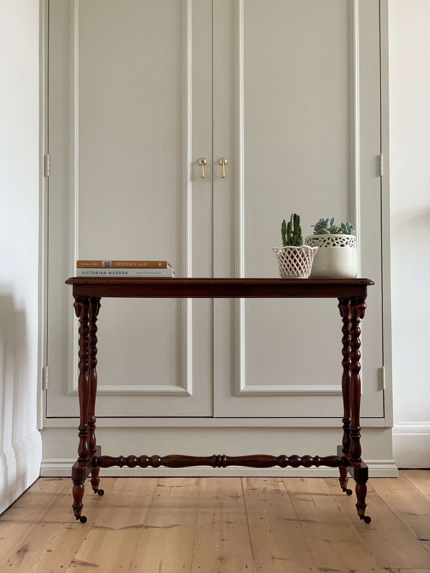 Antique bobbin console table on casters