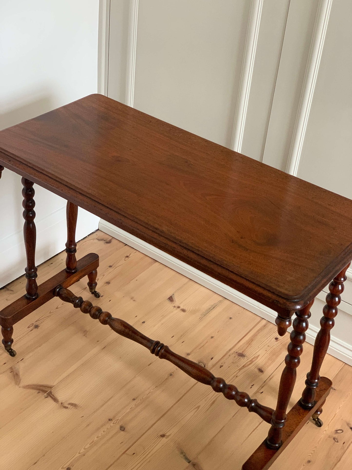 Antique bobbin console table on casters