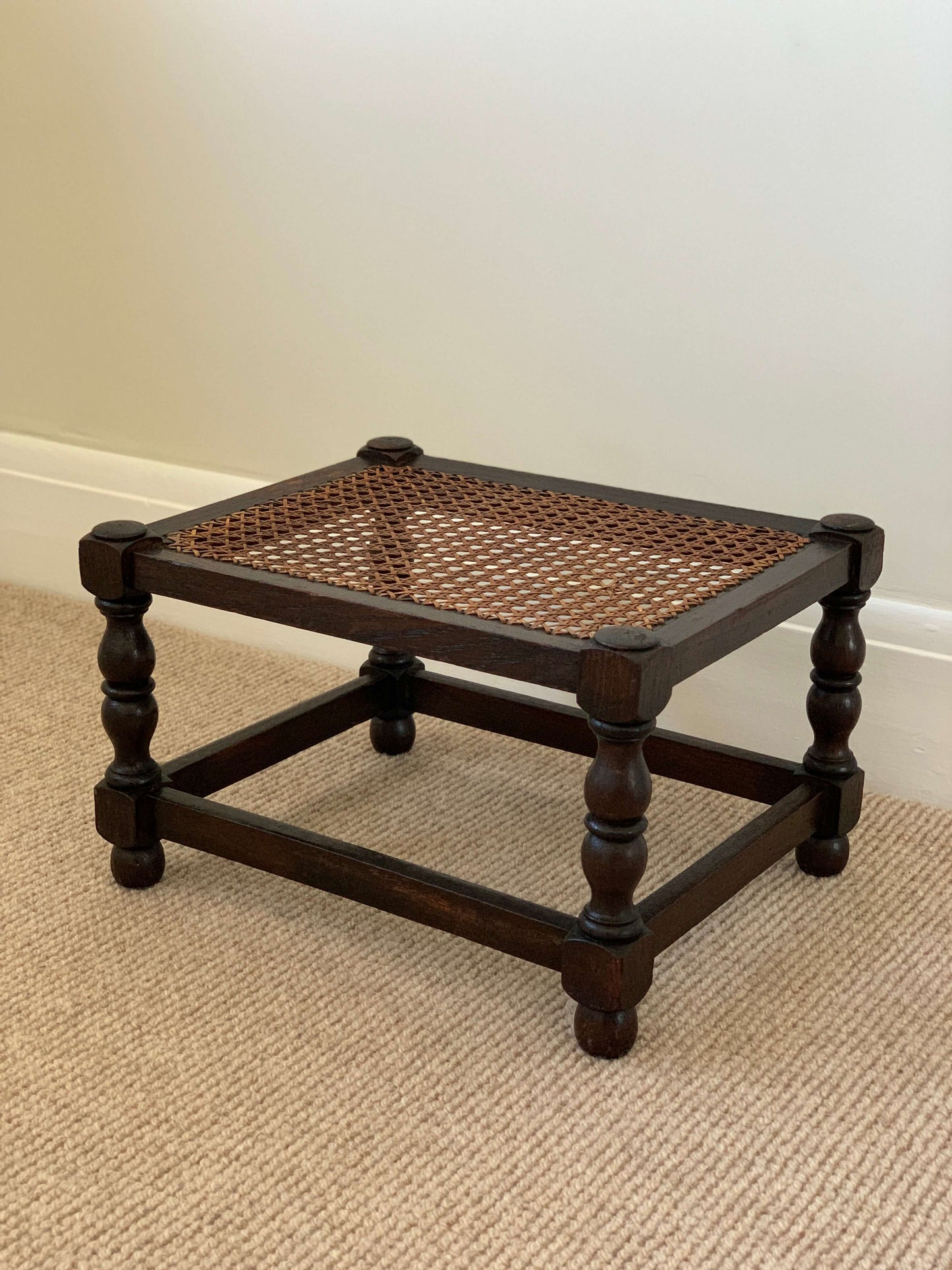 Antique cane stool with bobbin legs