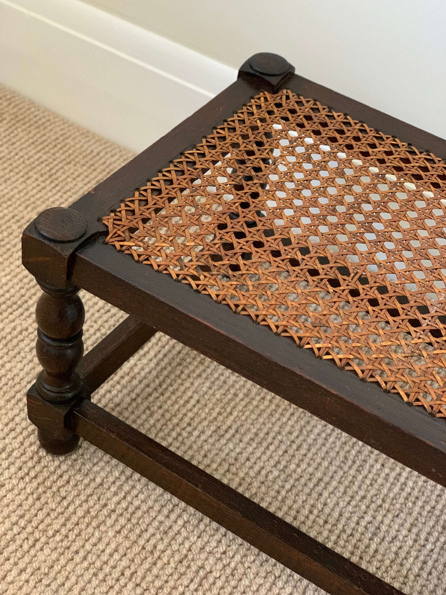 Antique cane stool with bobbin legs