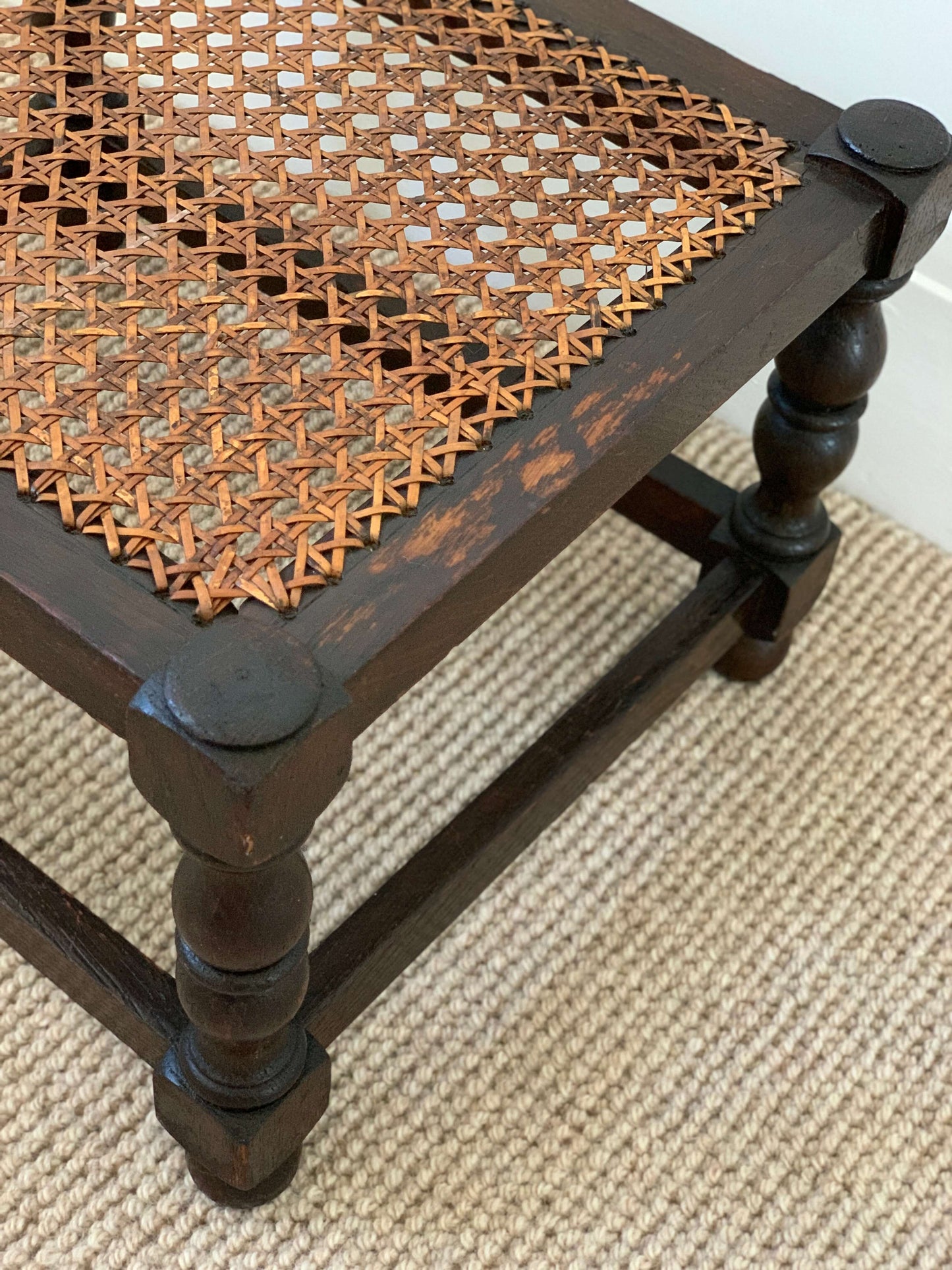Antique cane stool with bobbin legs
