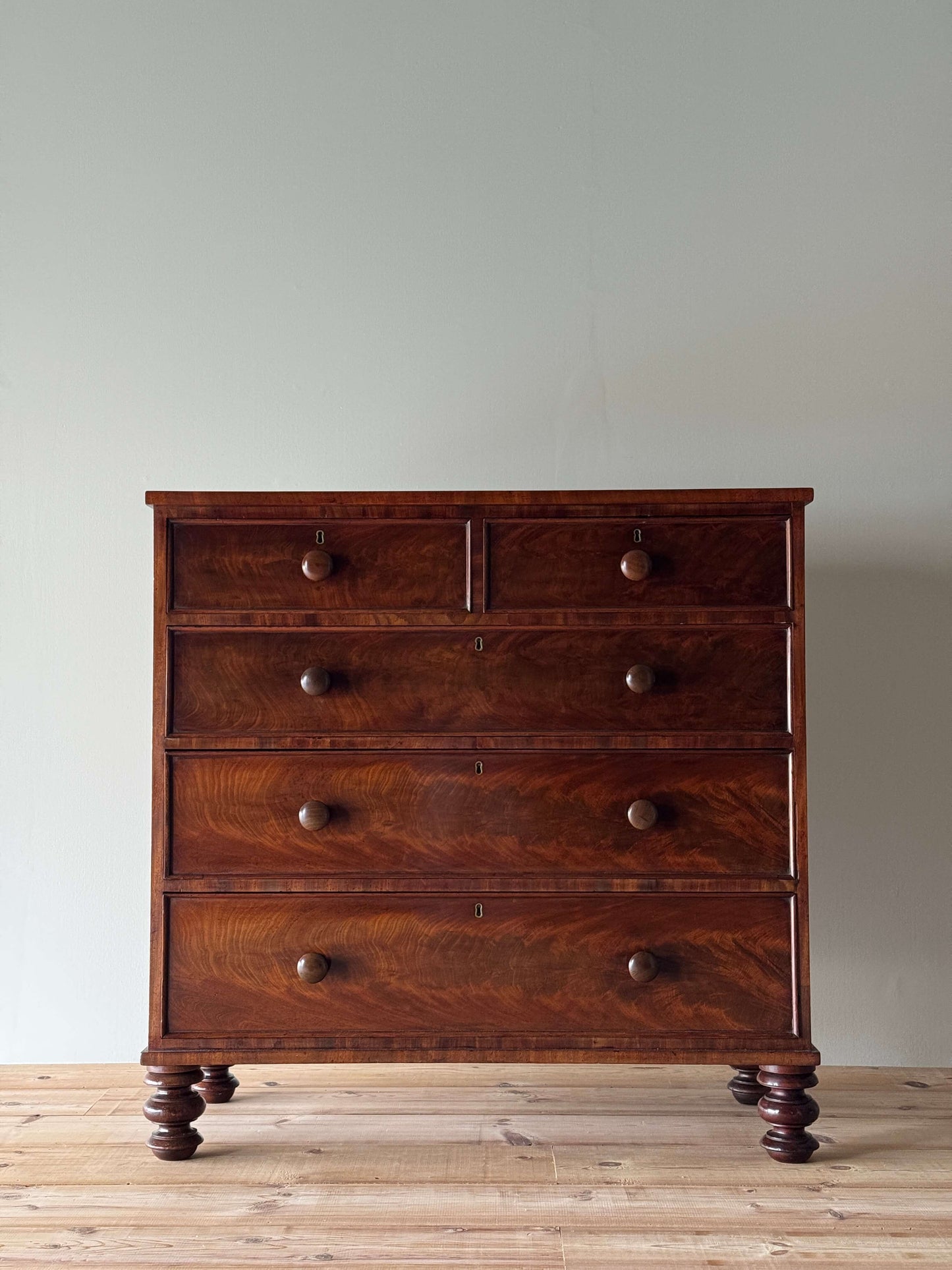 Victorian mahogany chest of drawers raised on turned feet