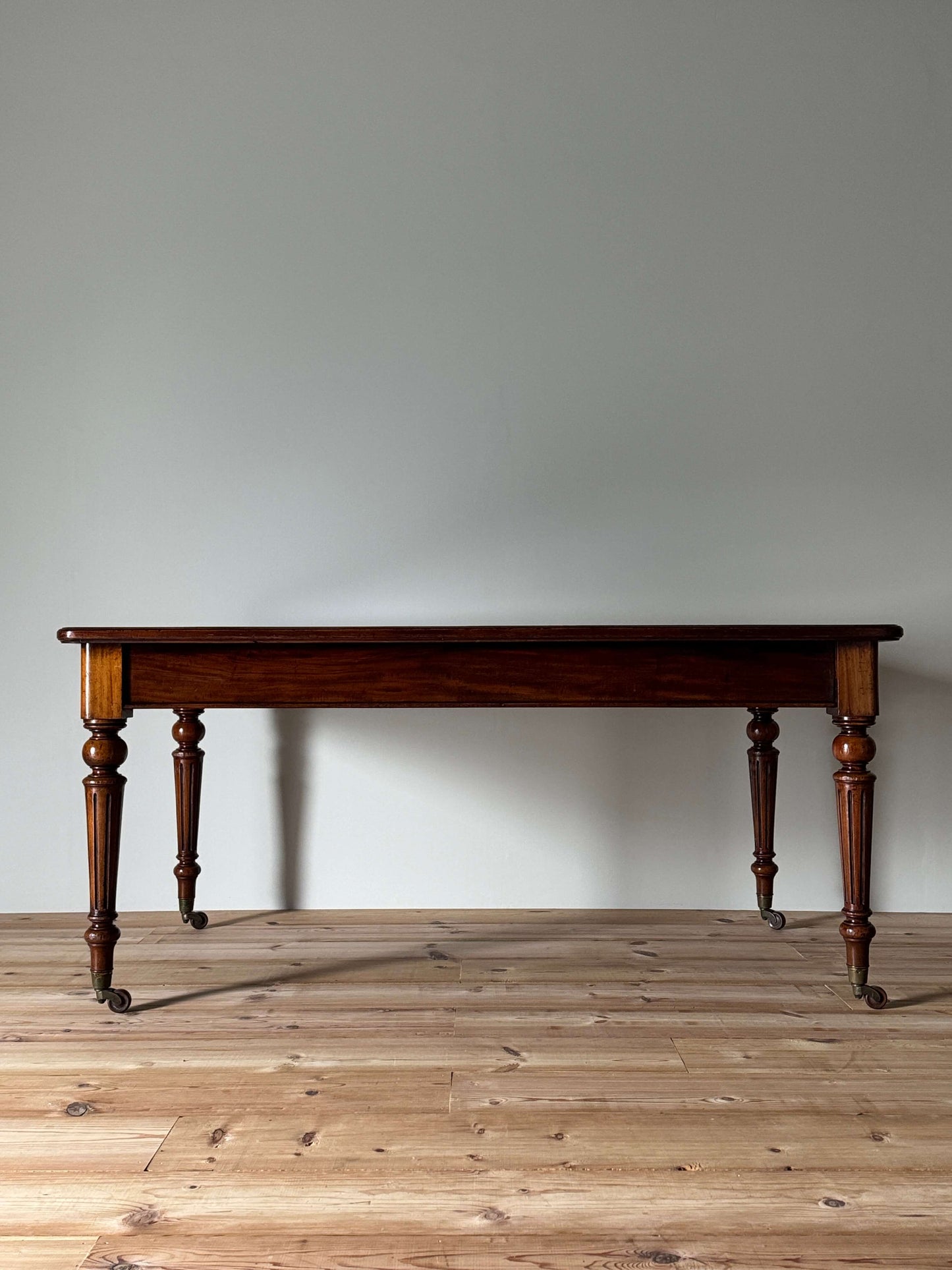 Victorian mahogany dining table on casters