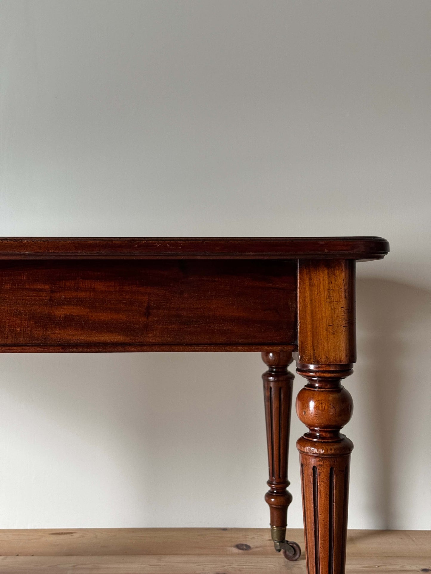 Victorian mahogany dining table on casters