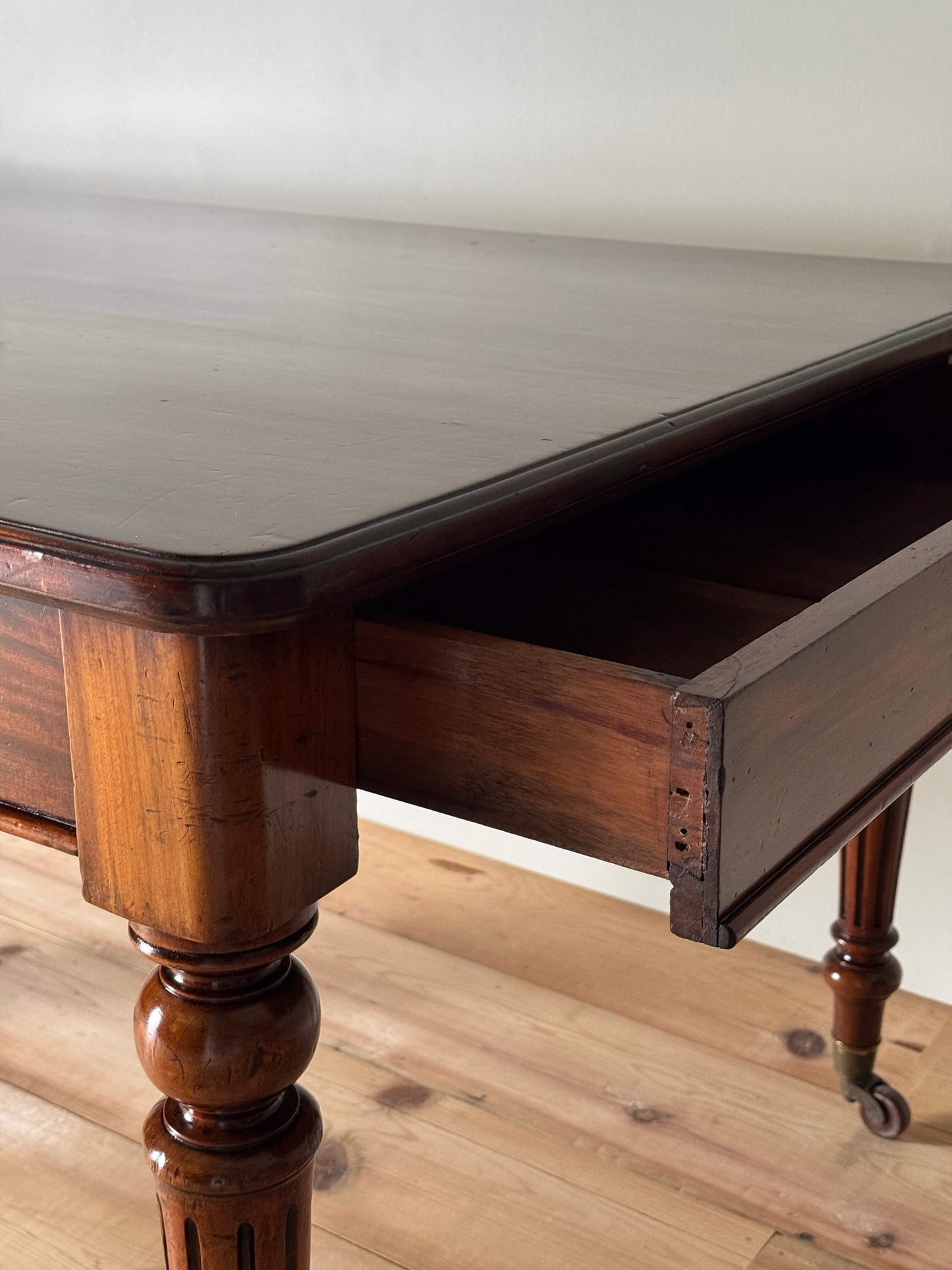 Victorian mahogany dining table on casters