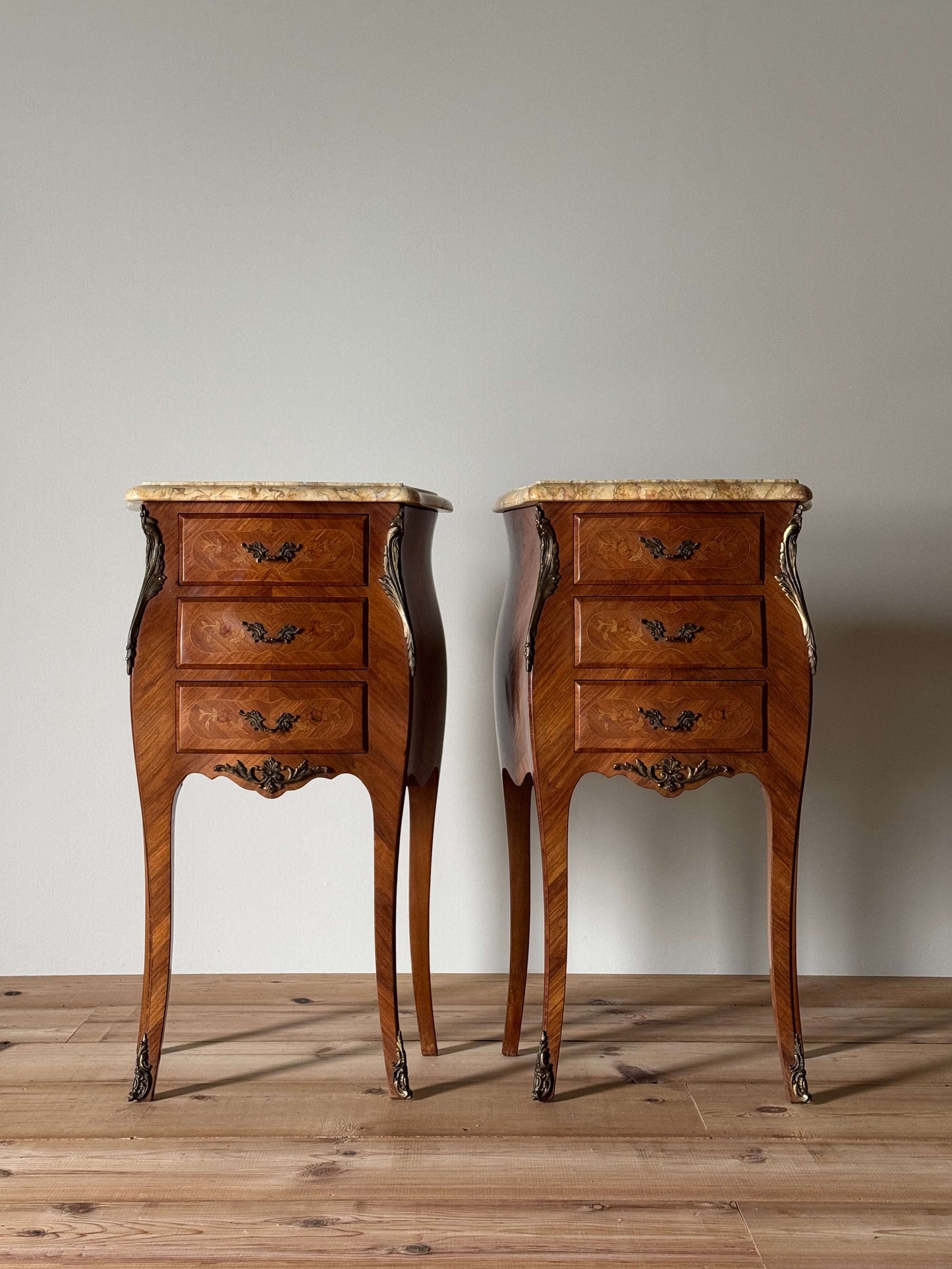 Pair of French antique marquetry bedside tables with marble tops
