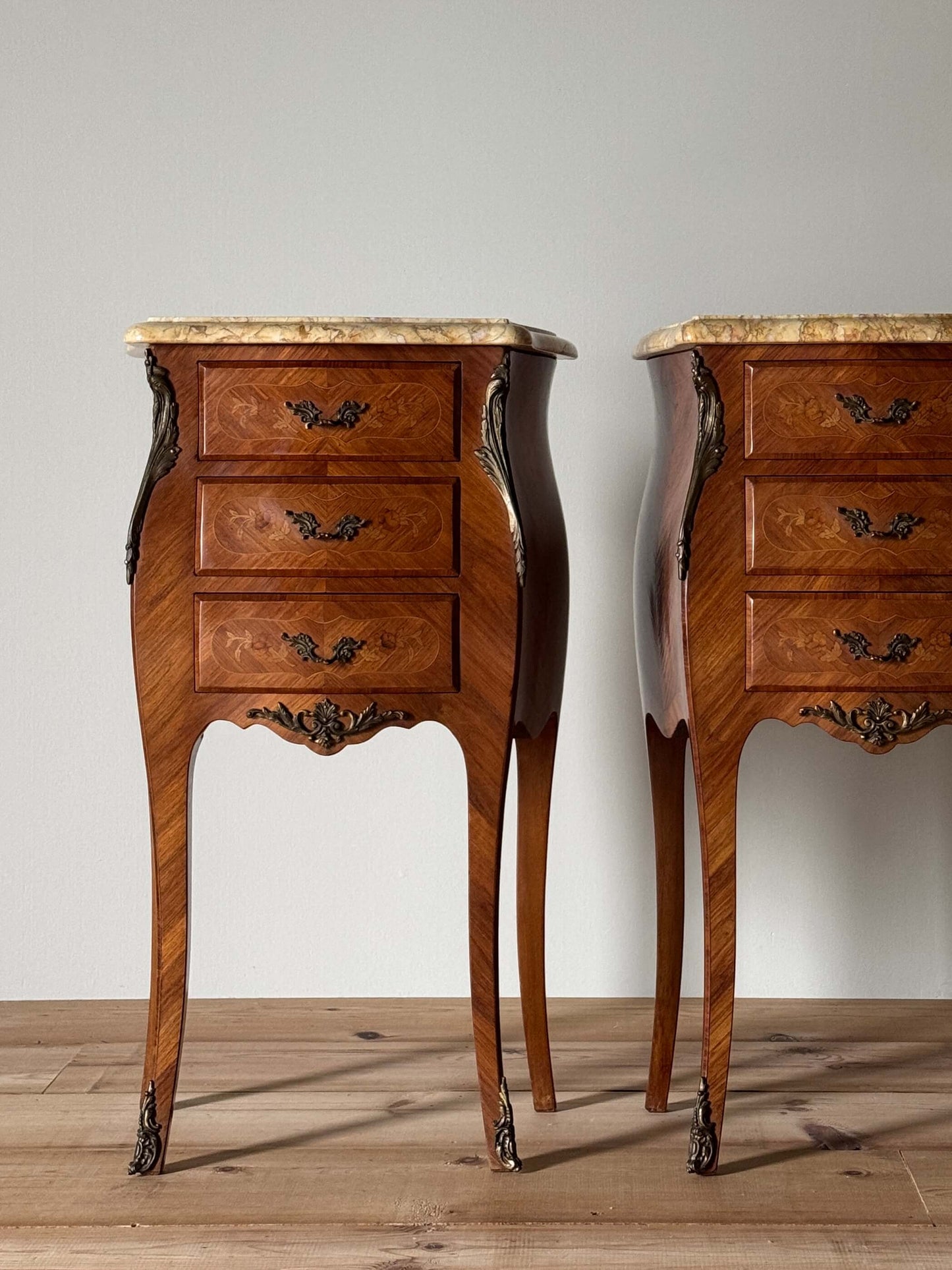 Pair of French antique marquetry bedside tables with marble tops
