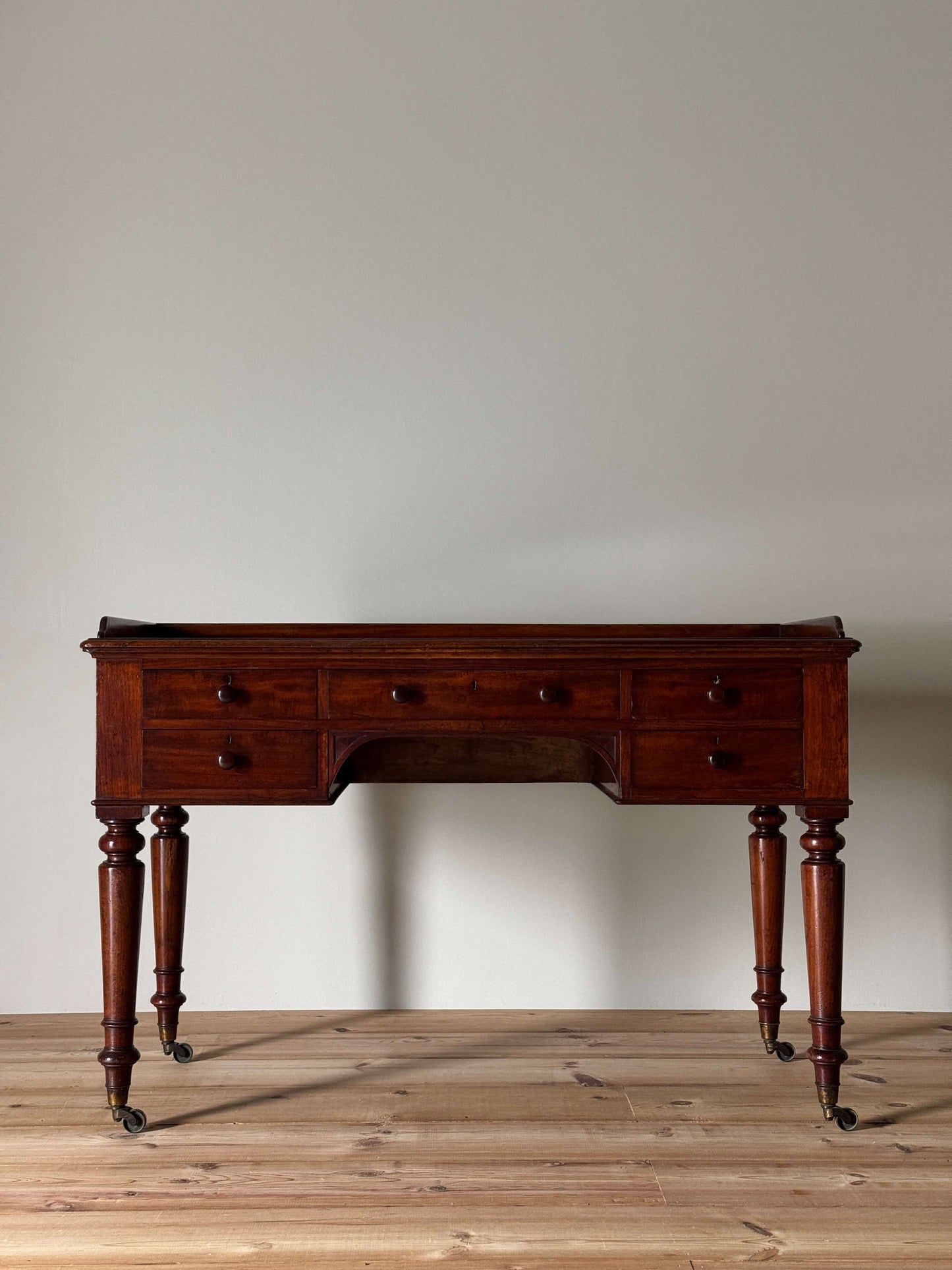 Early Victorian mahogany desk on castors