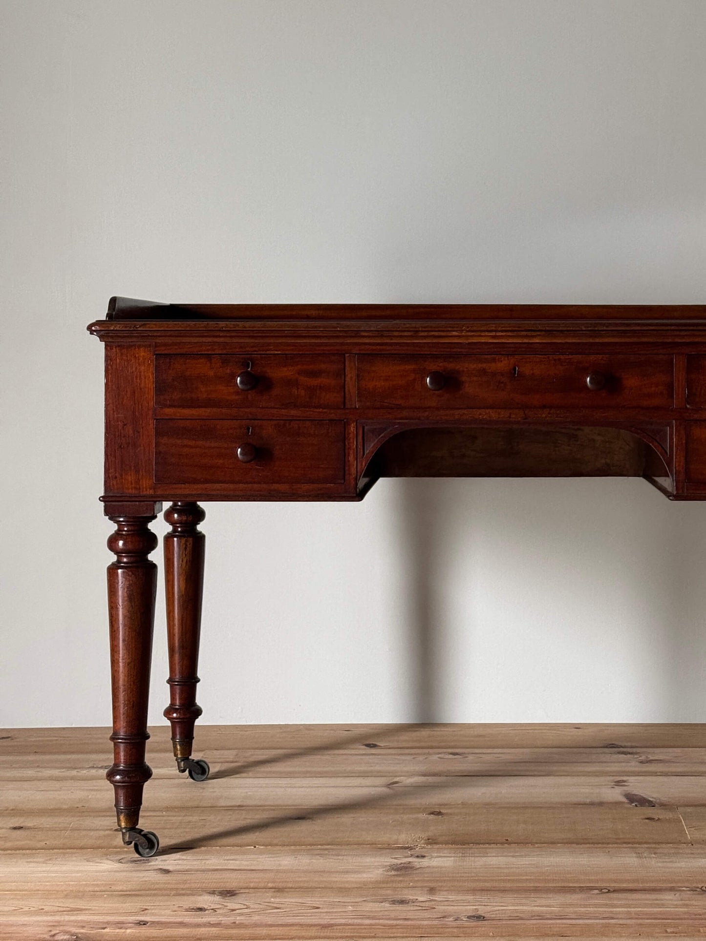 Early Victorian mahogany desk on castors