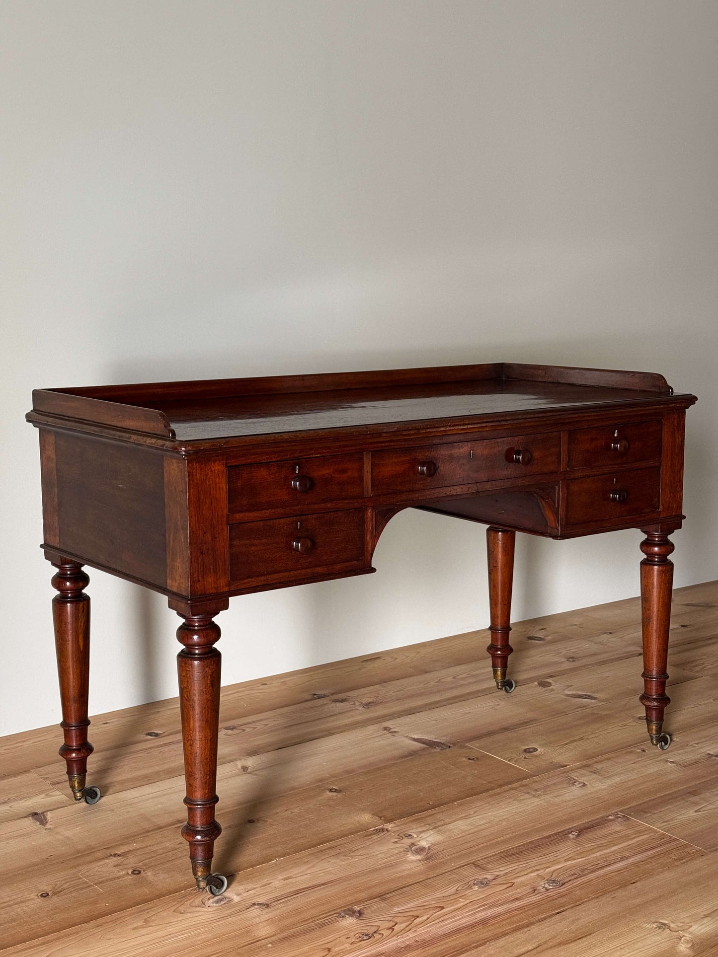 Early Victorian mahogany desk on castors