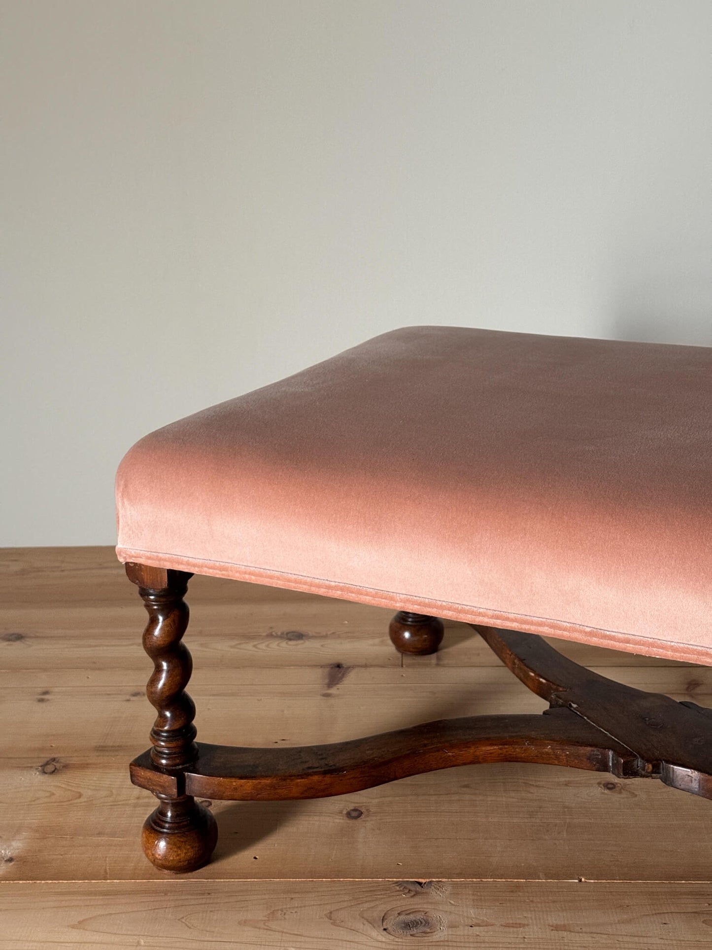 Antique footstool raised on barley twist supports