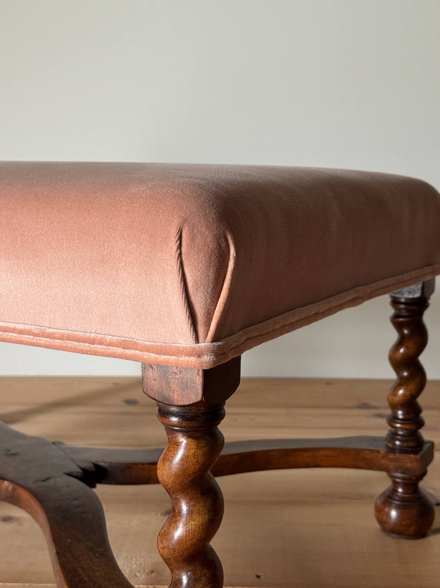 Antique footstool raised on barley twist supports