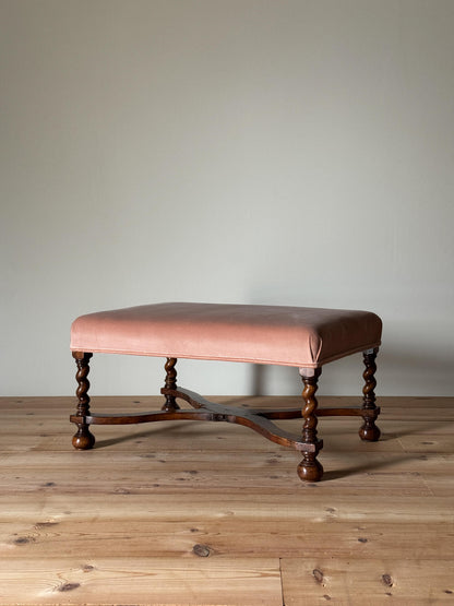 Antique footstool raised on barley twist supports