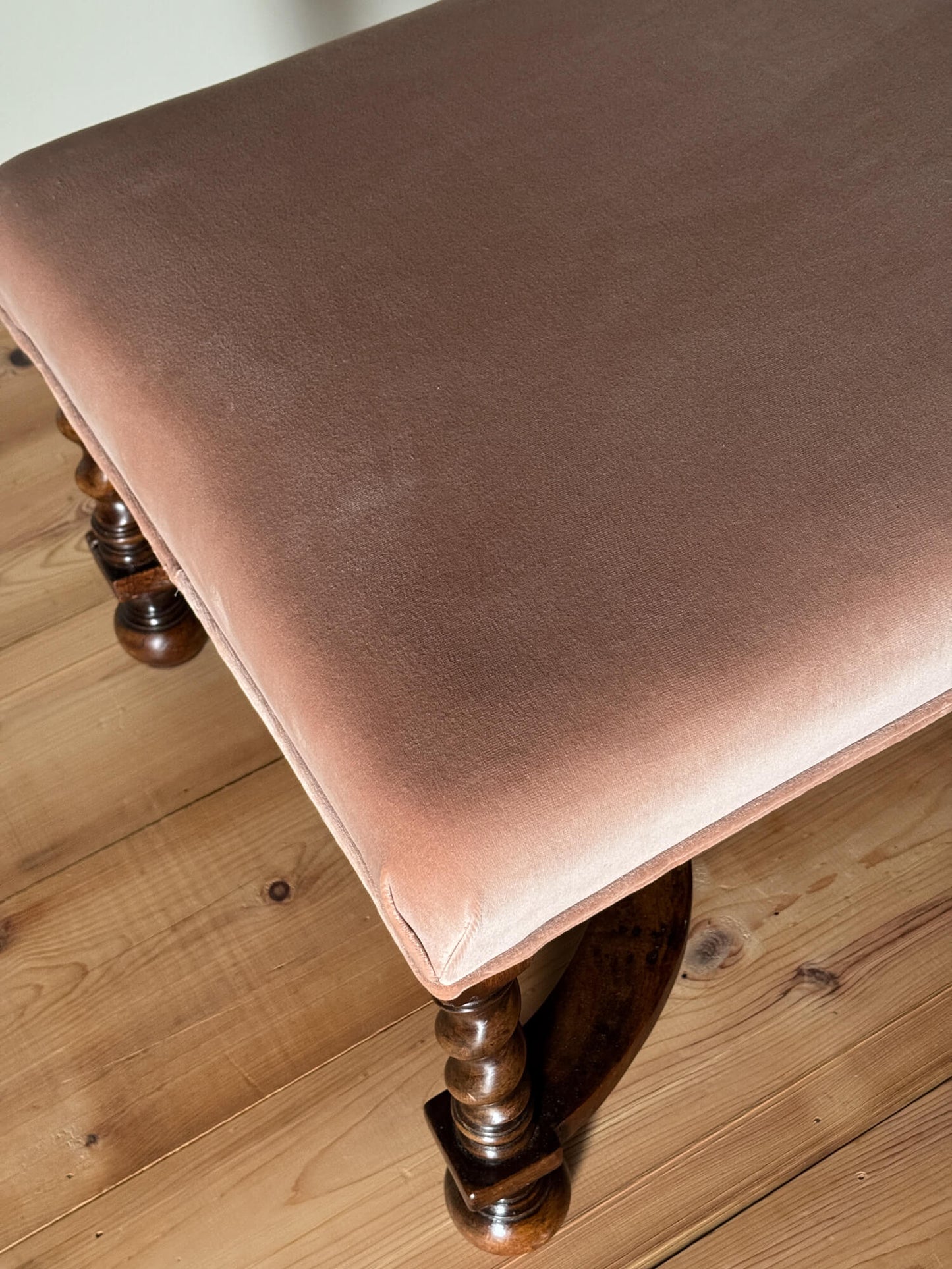 Antique footstool raised on barley twist supports