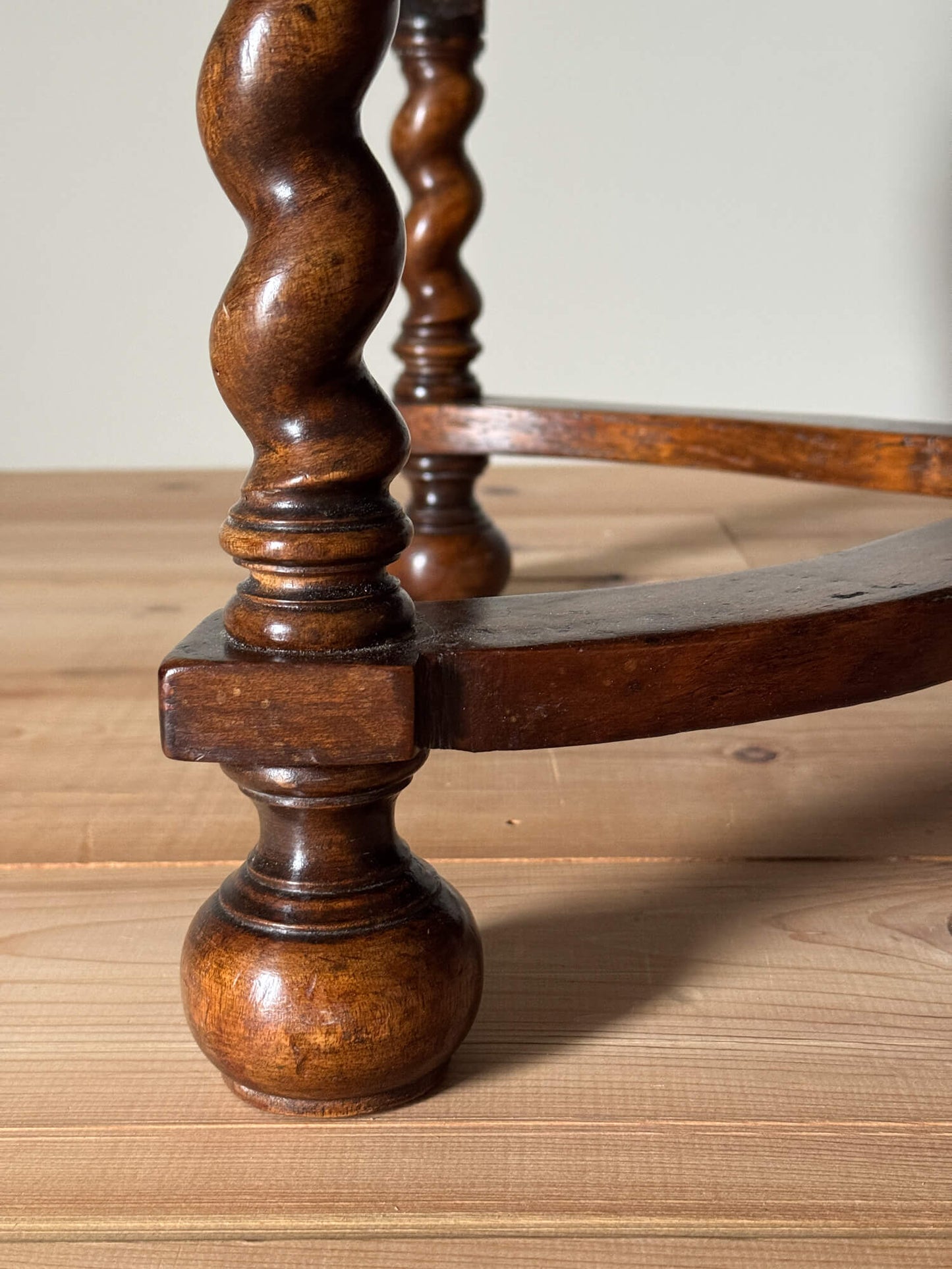 Antique footstool raised on barley twist supports