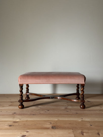 Antique footstool raised on barley twist supports