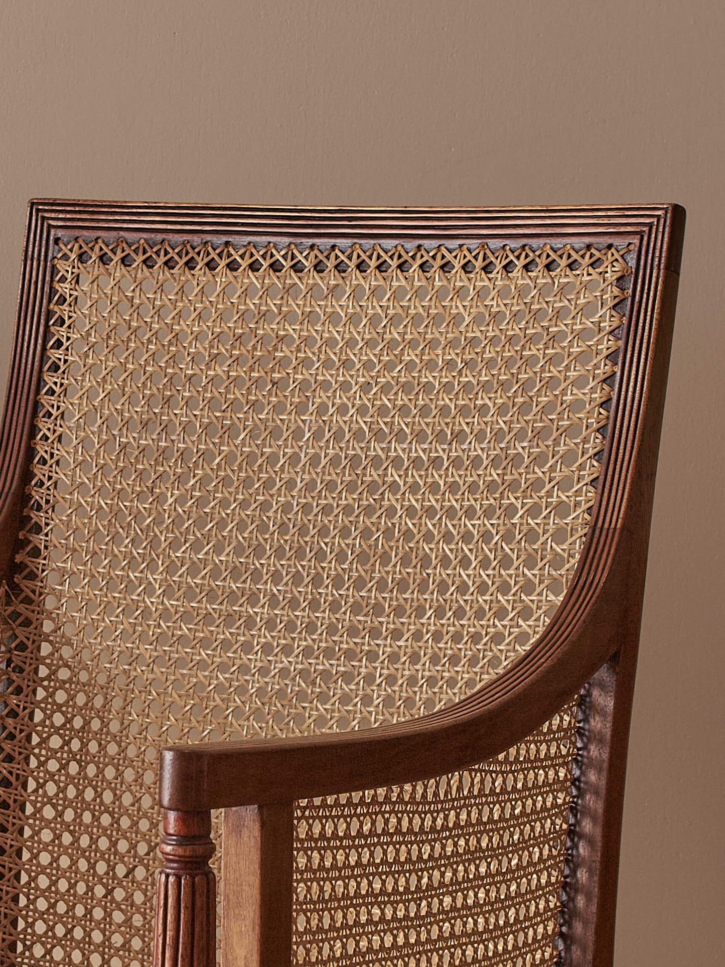 Pair of antique bergère chairs raised on brass castors