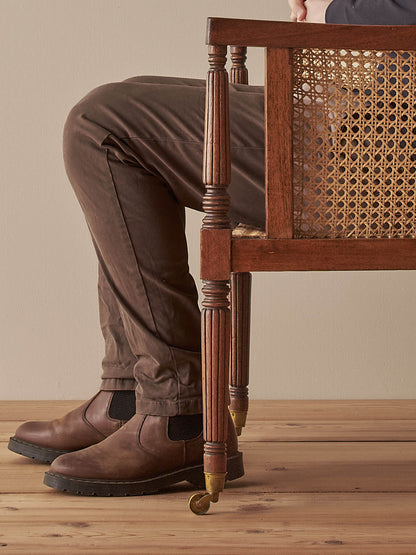 Pair of antique bergère chairs raised on brass castors