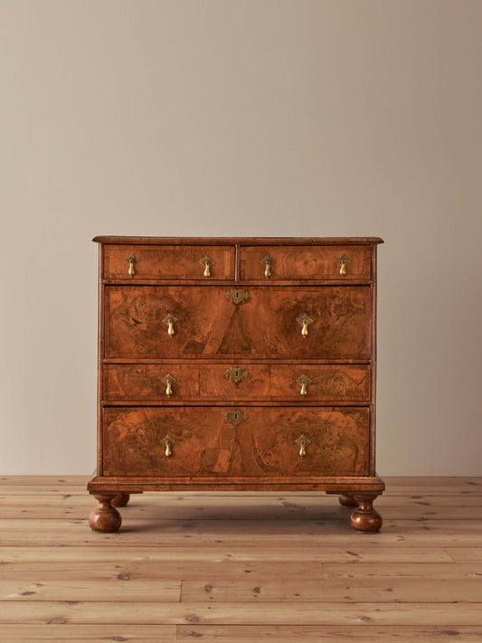 Queen Anne walnut chest of drawers raised on bun feet