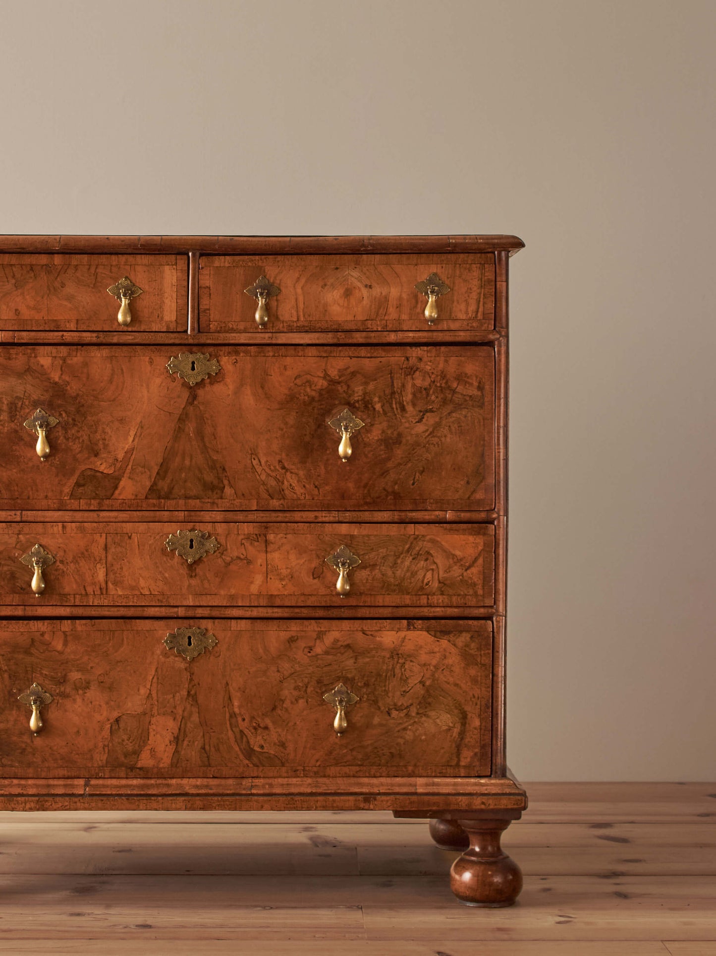 Queen Anne walnut chest of drawers raised on bun feet
