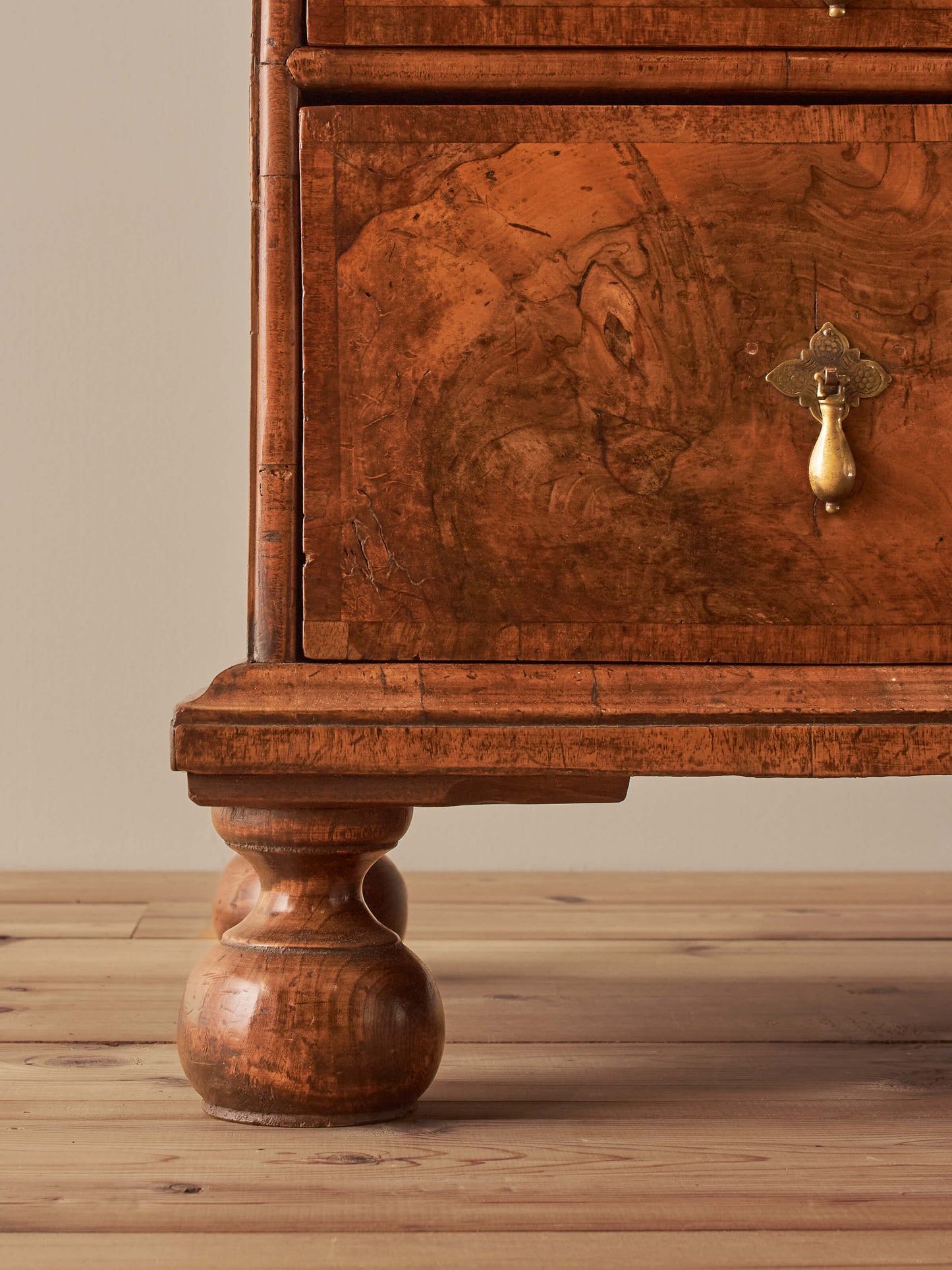 Queen Anne walnut chest of drawers raised on bun feet