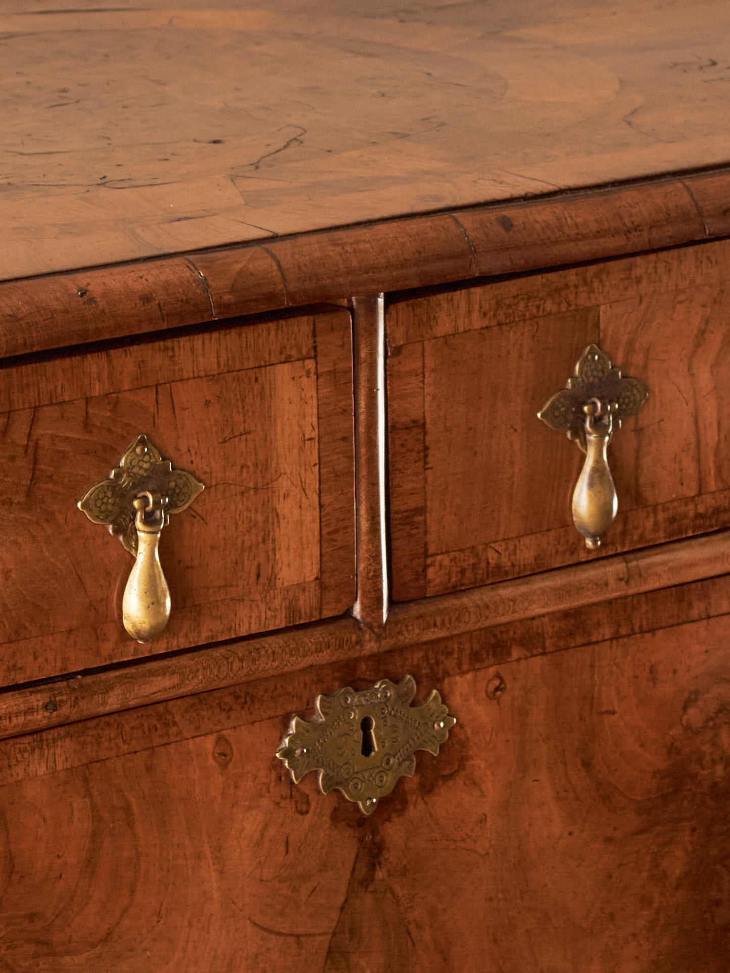 Queen Anne walnut chest of drawers raised on bun feet
