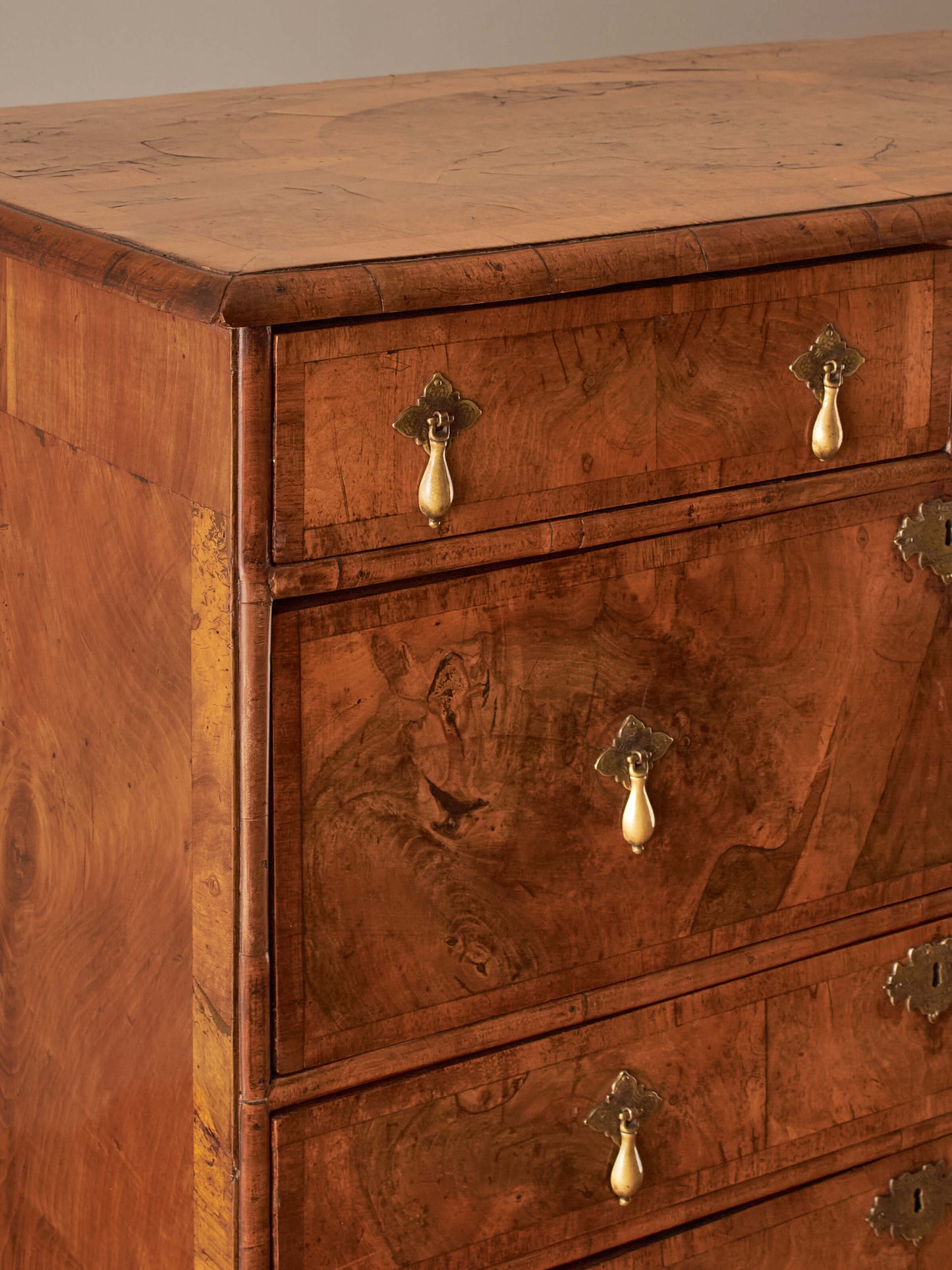 Queen Anne walnut chest of drawers raised on bun feet