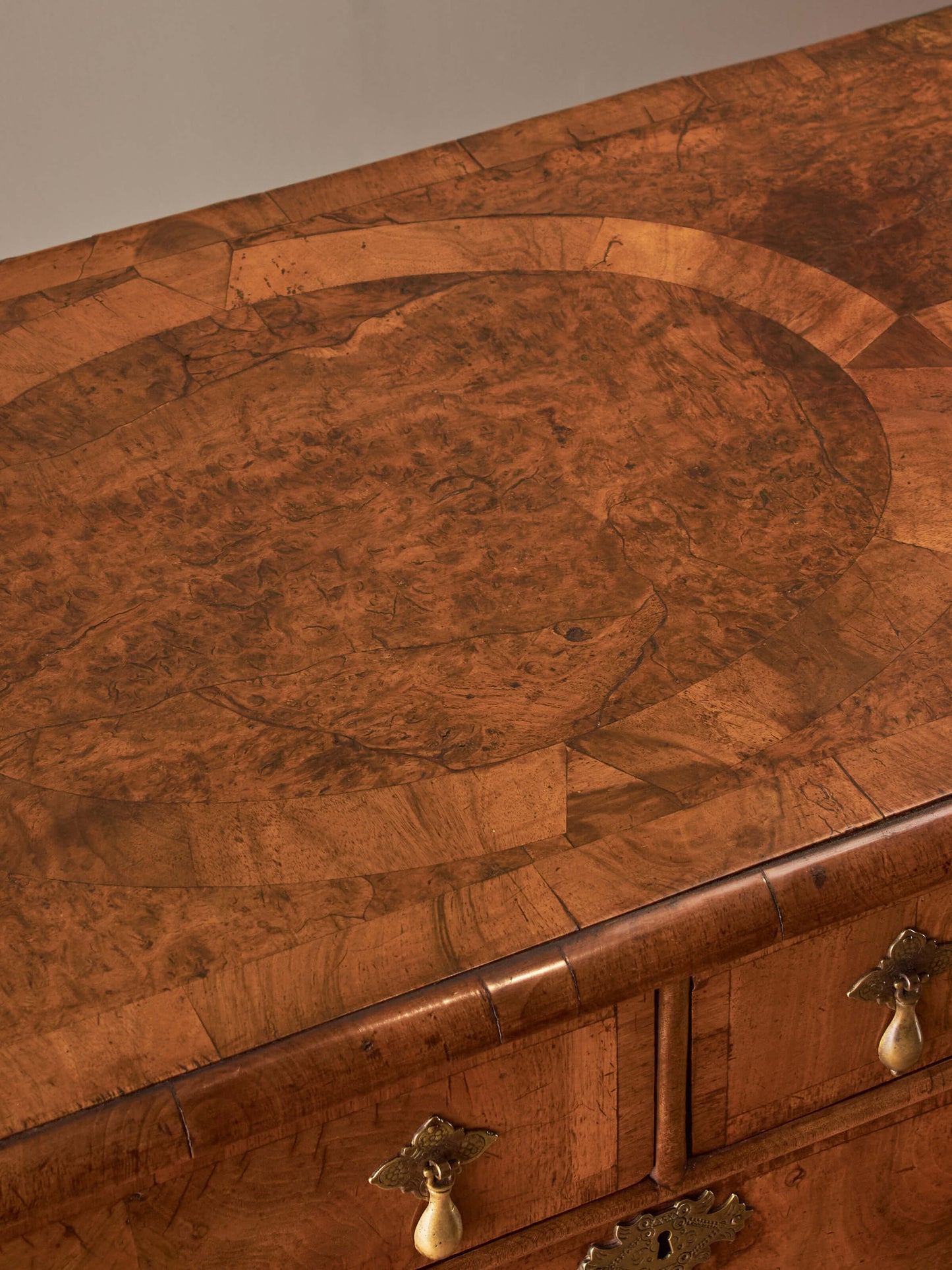 Queen Anne walnut chest of drawers raised on bun feet
