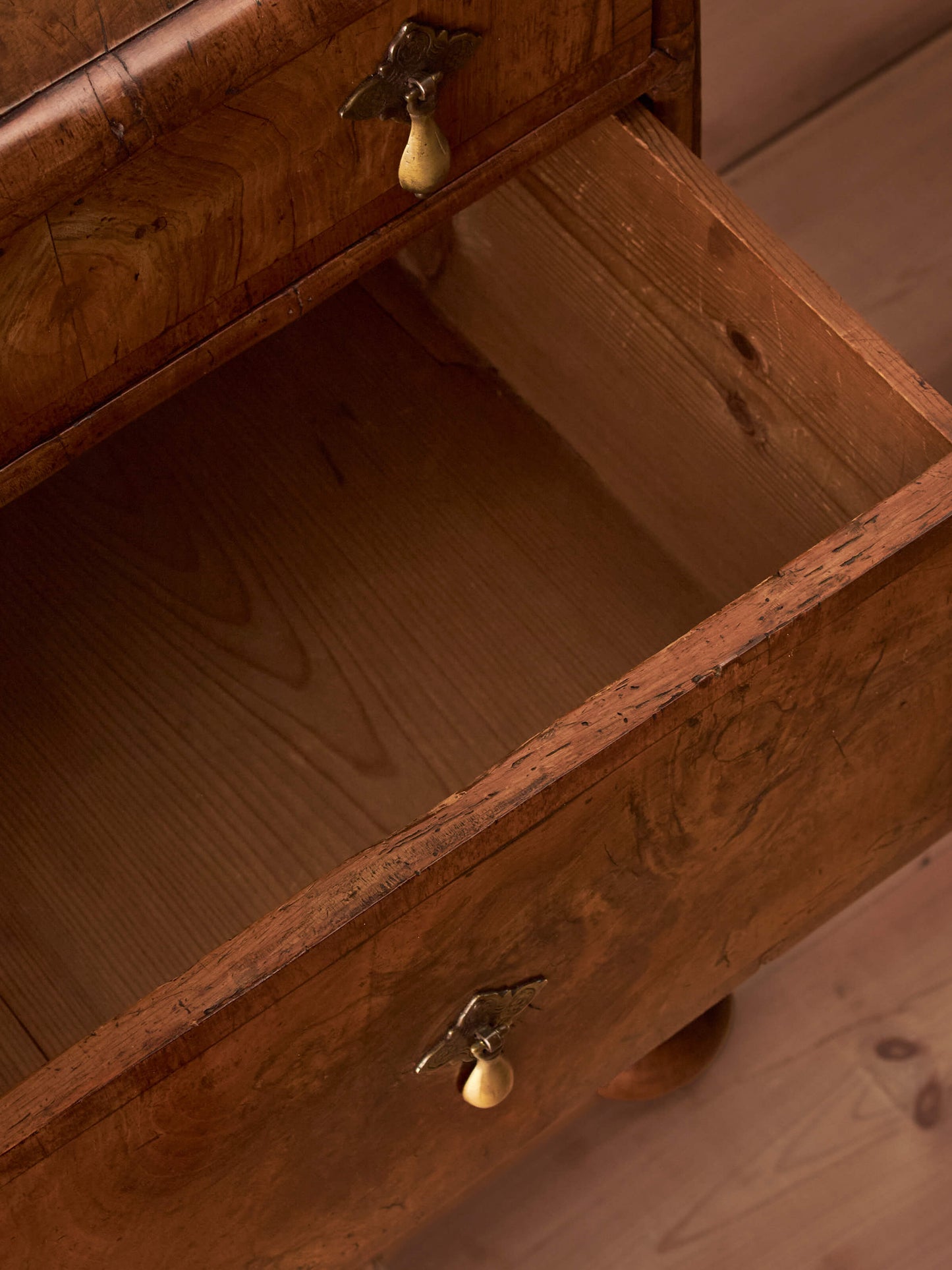 Queen Anne walnut chest of drawers raised on bun feet