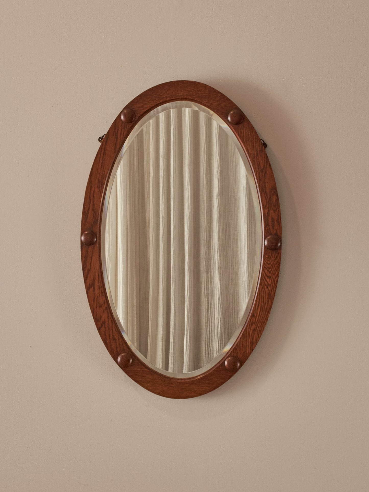 Antique oak oval mirror with circular details