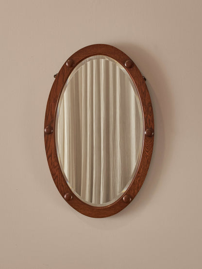Antique oak oval mirror with circular details