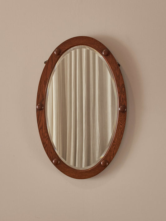 Antique oak oval mirror with circular details