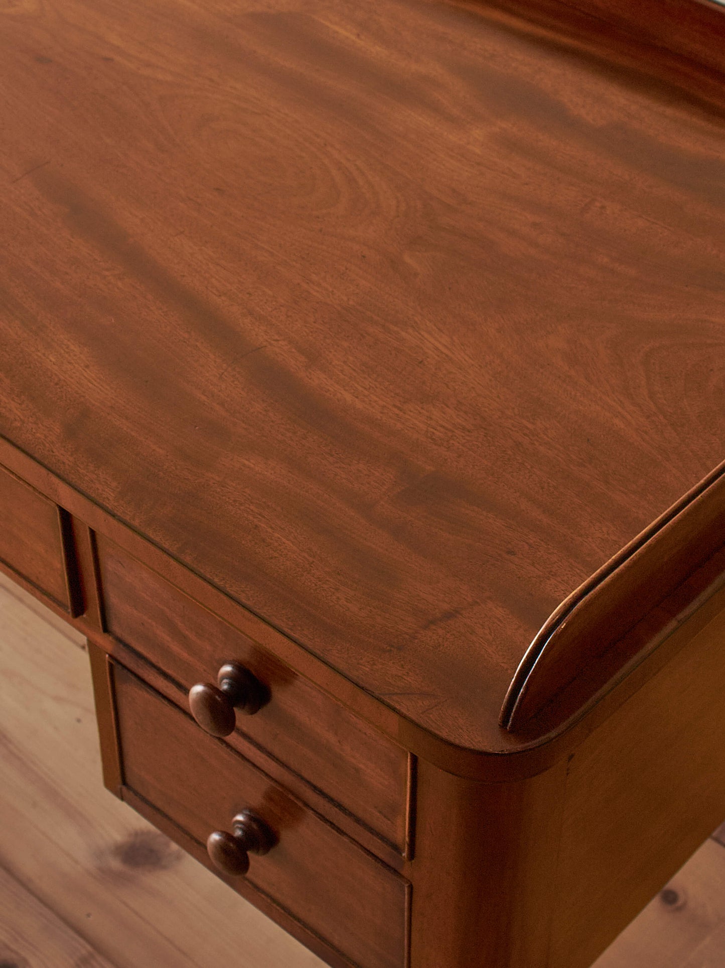 Antique Victorian mahogany writing desk on castors